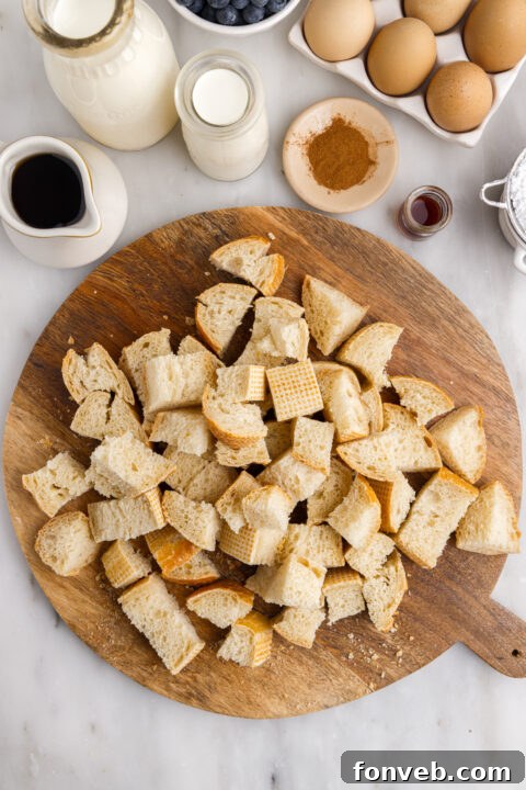 A close-up of a single serving of Blueberry French Toast Casserole garnished with fresh blueberries.