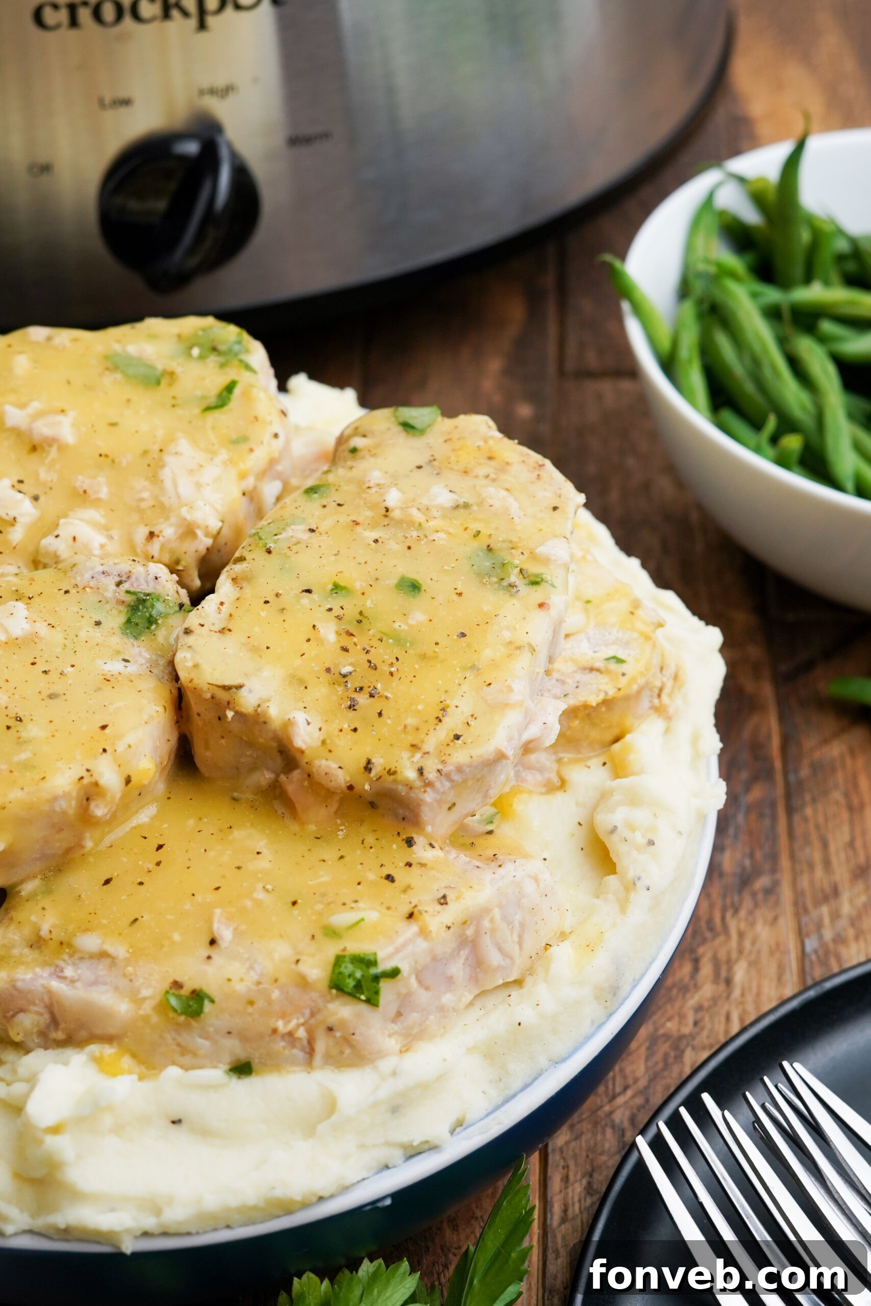 Close up view of Crock Pot Ranch Pork Chops served over mashed potatoes.