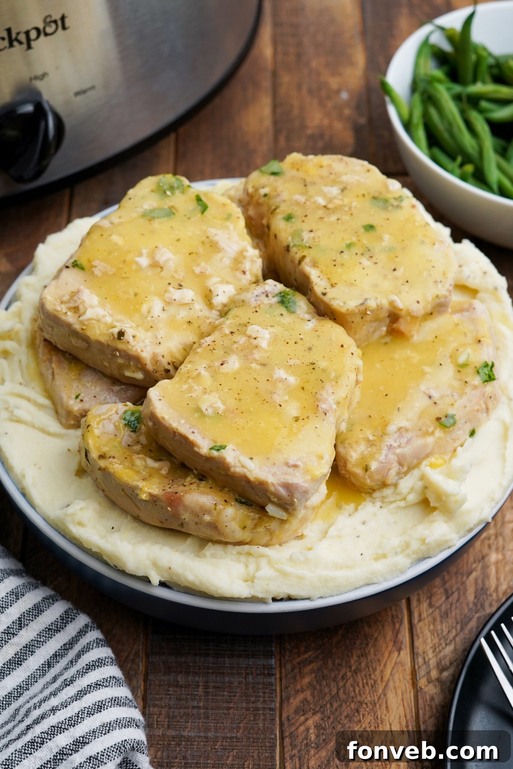Close up shot of Crock Pot Ranch Pork Chops served over mashed potatoes.