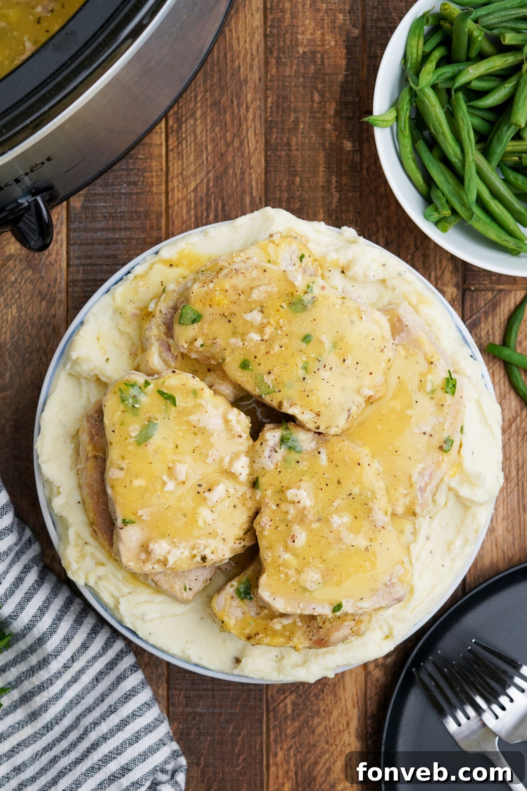Overhead view of Crock Pot Ranch Pork Chops served over mashed potatoes.