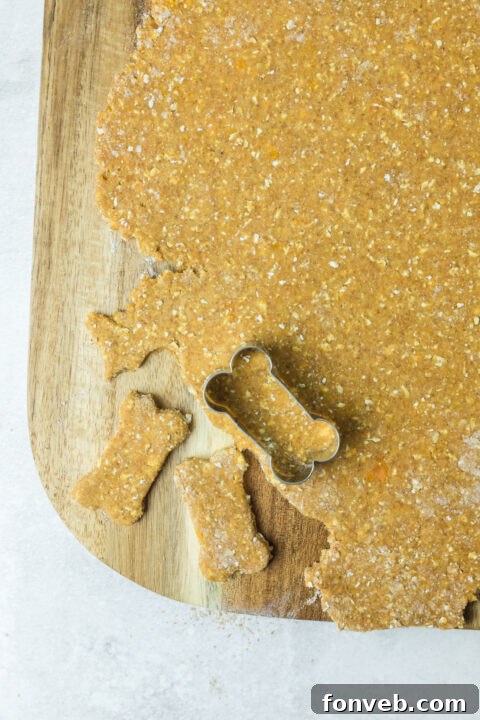 The dough for Sweet Potato and Pumpkin Dog Treats rolled out on a floured surface, ready for cutting into shapes.