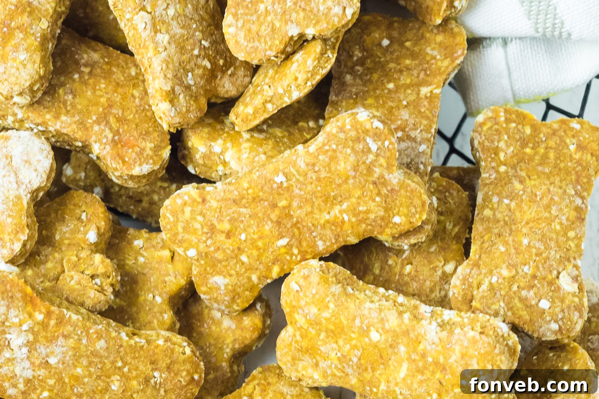 Another close-up shot of the Sweet Potato and Pumpkin Dog Treats nestled in a wire basket, with soft natural light highlighting their texture and homemade appeal.