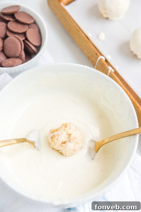 Melted white candy coating in a bowl, showing its silky smooth consistency, perfect for dipping the truffles.