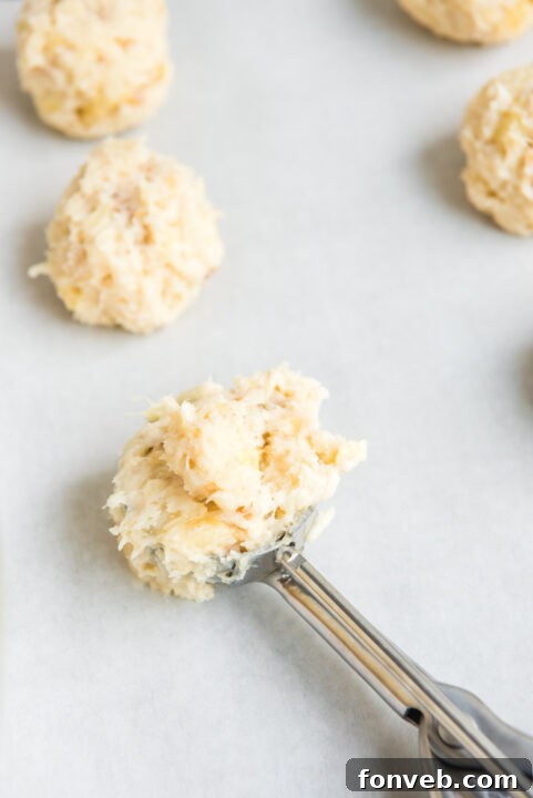 Close-up of the truffle mixture being rolled into perfect spherical balls by hand, emphasizing the smooth shaping process.