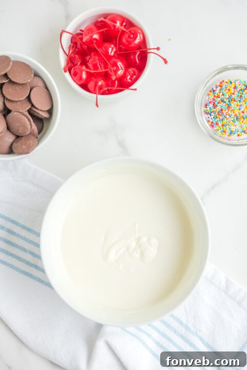 A tray of freshly rolled truffle balls resting on parchment paper, ready for their initial chilling period in the refrigerator.