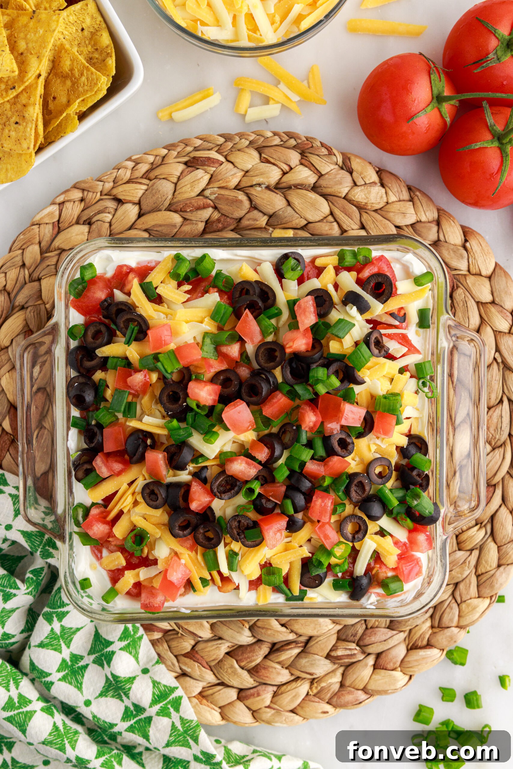 An overhead view of the inviting 7-Layer Dip in a clear baking dish, ready to be enjoyed as a centerpiece at any gathering.