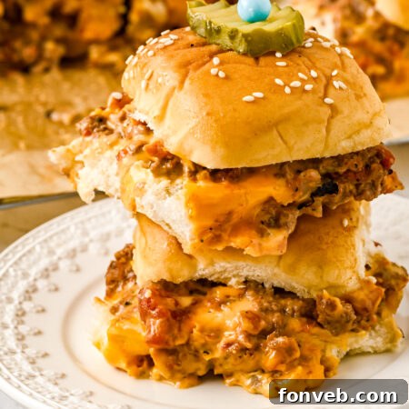 A stacked cheeseburger slider with a bite taken out, resting on a white plate, symbolizing the delicious outcome of the recipe.