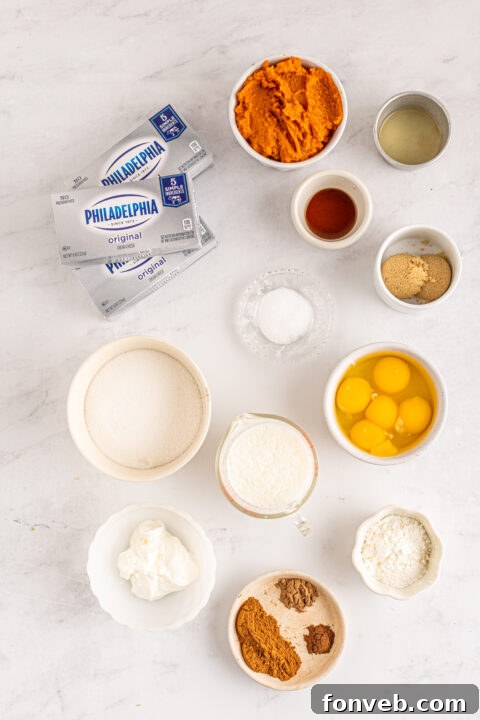 Spiced Fall Cheesecake Bites 8 A close-up of a mini pumpkin cheesecake with a golden crust and smooth filling.