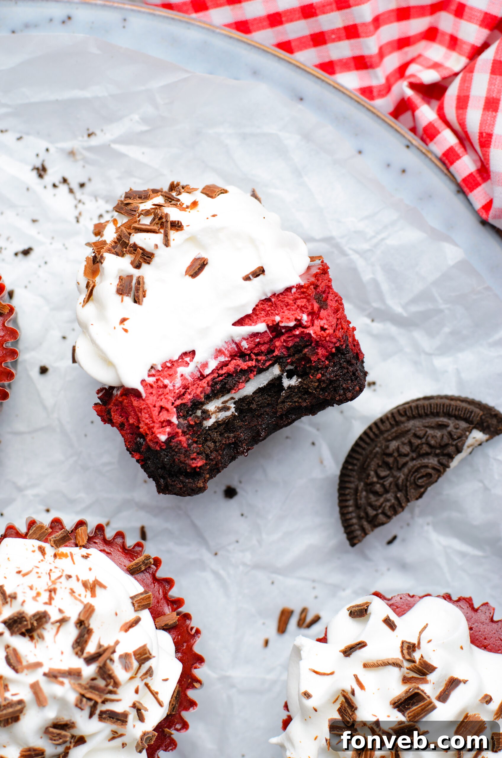 Ruby Red Oreo Cheesecake Gems 18 Overhead view of a Mini Red Velvet Oreo Cheesecake on its side with a bite removed.
