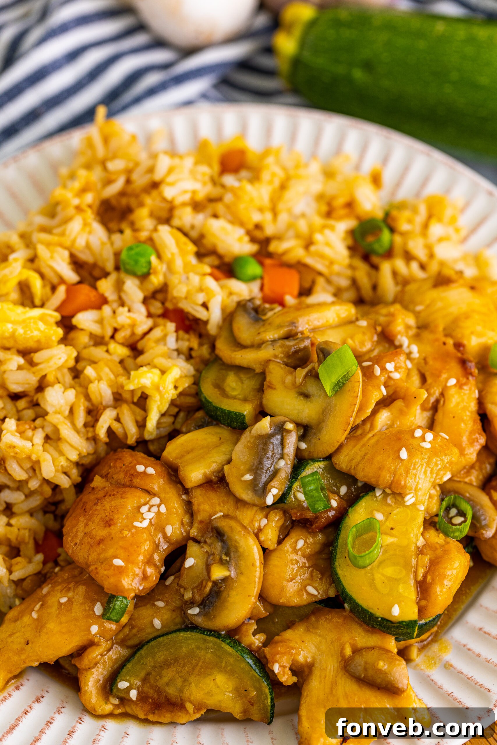 Panda Express Mushroom Chicken on a white plate with a side of fried rice