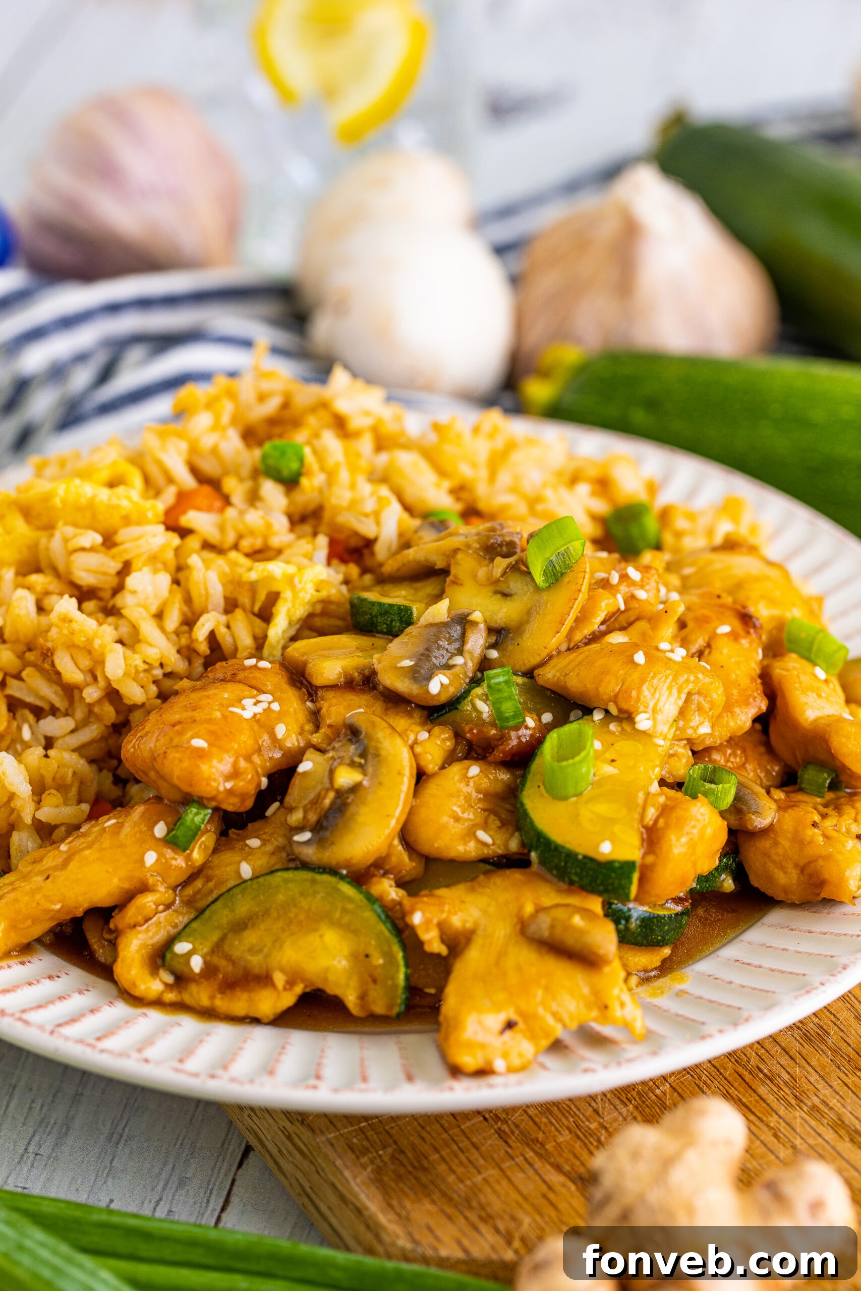 Close up view of Panda Express Mushroom Chicken on a white dish served with fried rice. 