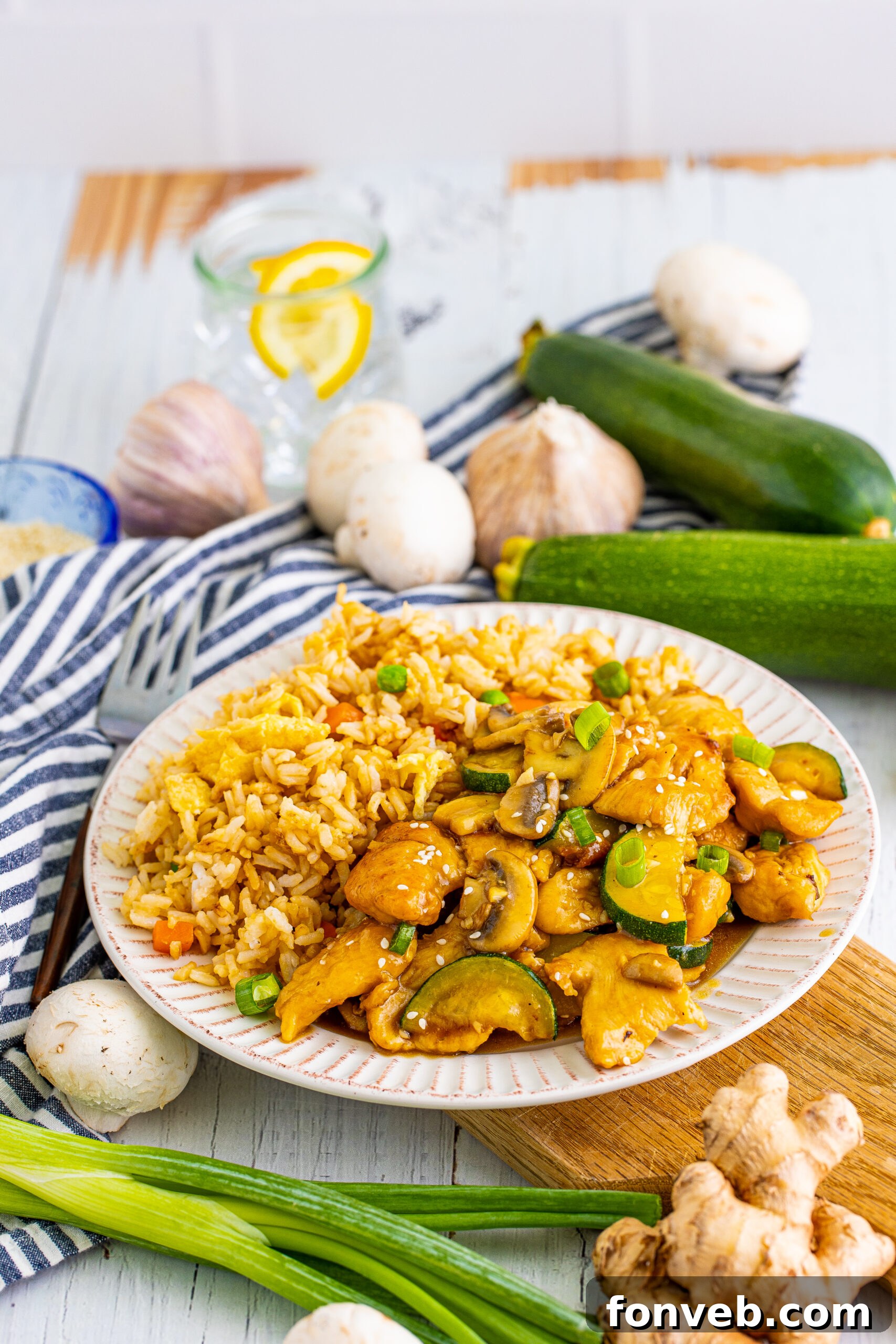 Front view of Panda Express Mushroom Chicken on a white dish served with fried rice. 
