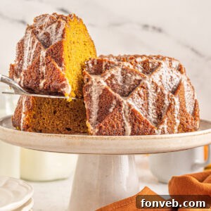 Harvest Pumpkin Bundt with Sweet Cinnamon Finish 16 Beautifully presented Pumpkin Bundt Cake with Cinnamon Sugar Glaze on a white cake stand.