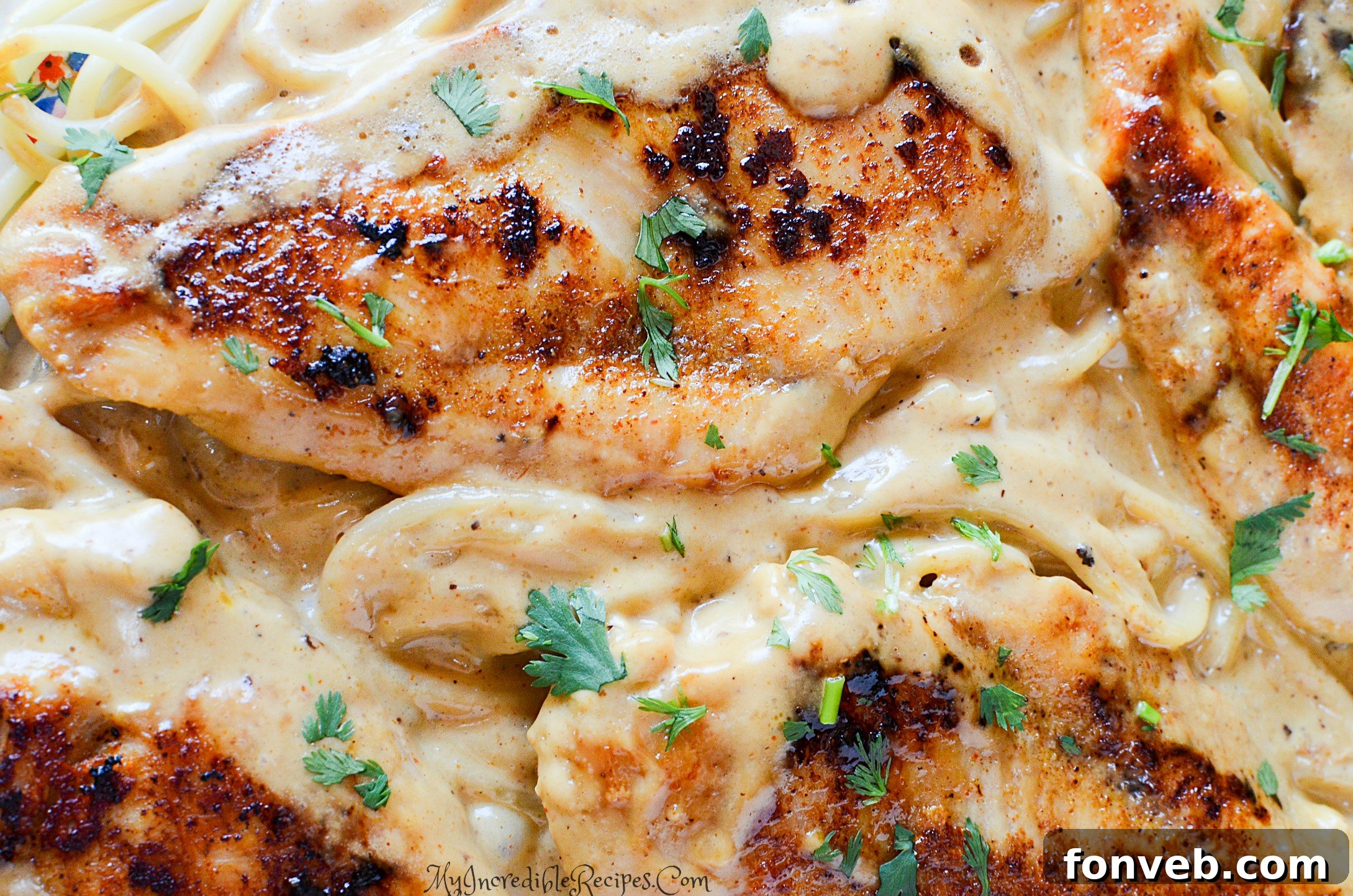 Chicken Lazone served with pasta, garnished with parsley