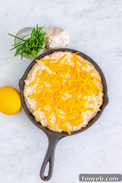 Overhead view of a small bowl of crab dip, highlighting the vibrant colors and appealing texture.