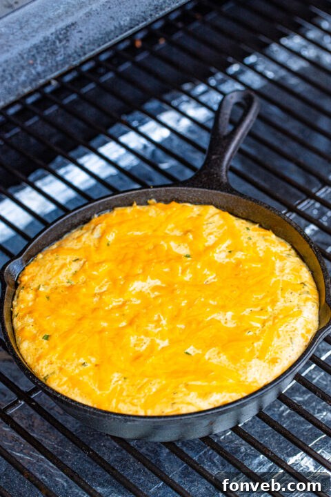 An appetizing close-up of a cracker loaded with the creamy crab dip, ready for a bite.
