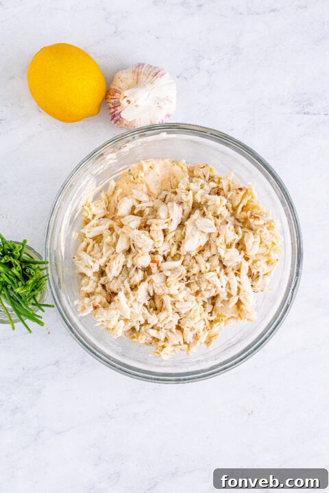 A close-up view revealing the creamy, cheesy interior of the crab dip, flecked with pieces of crab.