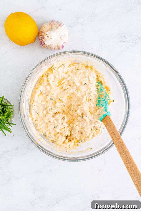 Textured shot of the dip with melted cheese on top, showing its readiness for serving.