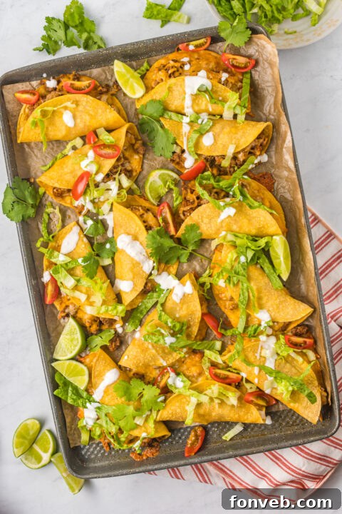 Golden Crispy Beef Tacos 17 A vibrant close-up of a Crispy Beef Taco, garnished with fresh cilantro and a lime wedge, highlighting the colorful toppings.