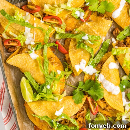 Overhead view of Crispy Beef Tacos on a sheet pan, ready for serving.
