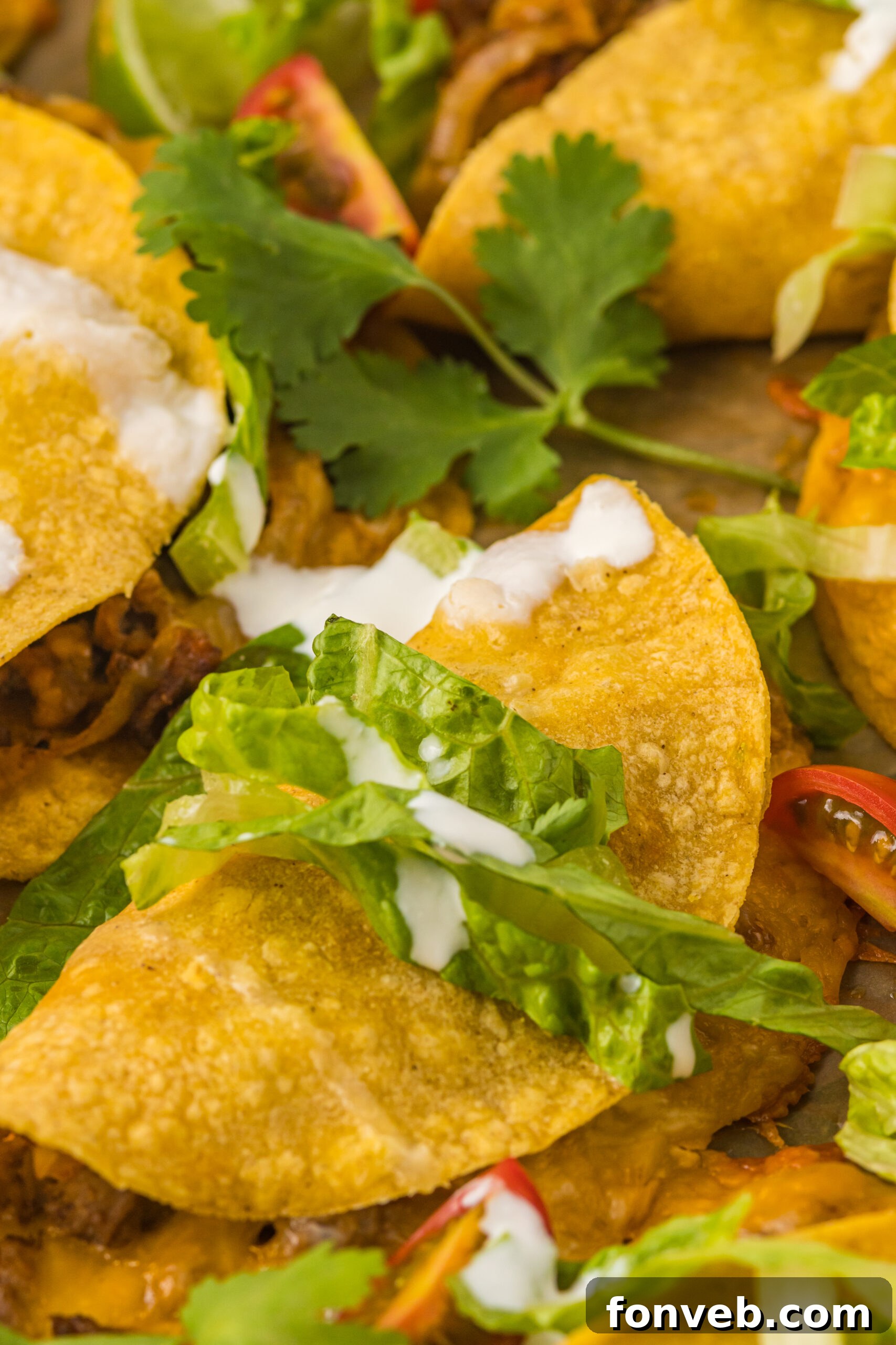 Golden Crispy Beef Tacos 6 Close-up view of Crispy Beef Tacos on a sheet pan, highlighting the golden texture of the shells and the rich filling.