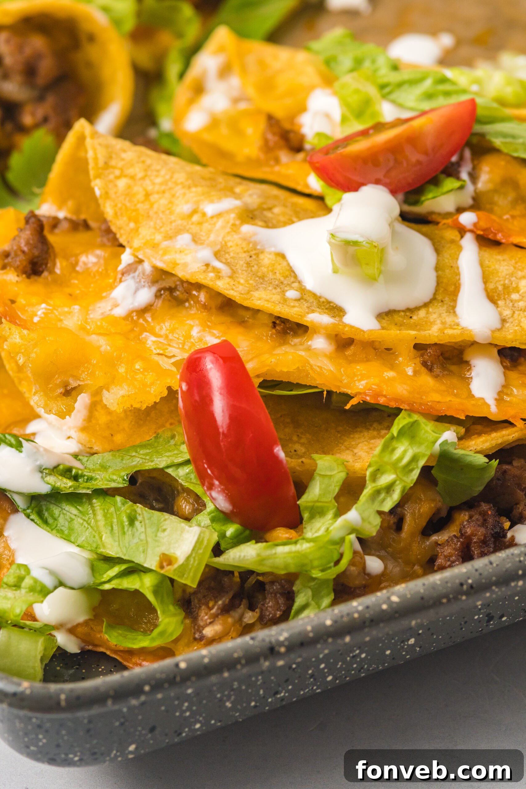 Golden Crispy Beef Tacos 7 Close-up view of a Crispy Beef Taco, showing the textured, golden-brown tortilla and the rich beef filling peeking out, with fresh cilantro garnish.