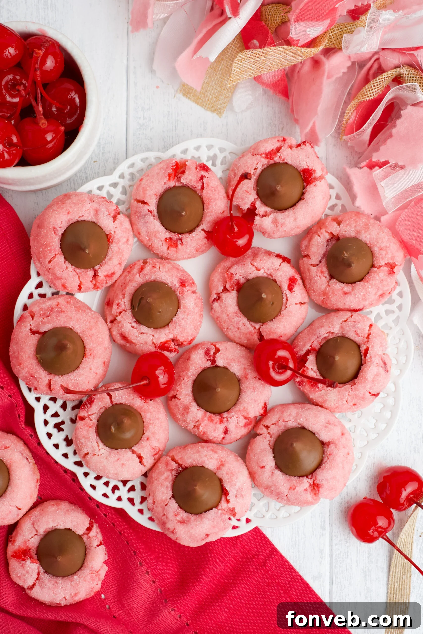 Overhead shot of freshly baked Cherry Blossom Cookies, showcasing their uniform shape and chocolate centers.