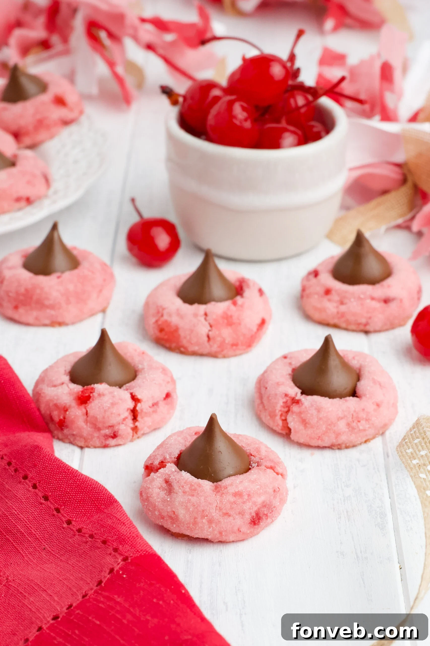 A row of baked Cherry Blossom Cookies, showing their perfectly round shape and melted chocolate tops.