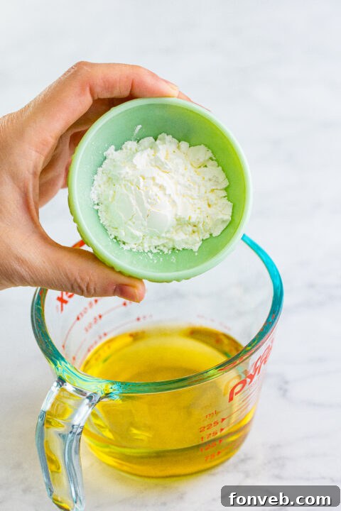Apples simmering gently in a covered skillet to tenderize.