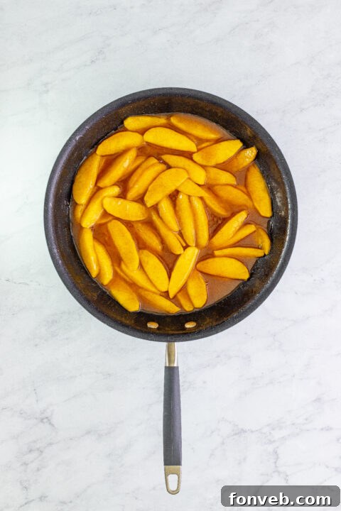 Thickened Cracker Barrel Fried Apples with a glossy sauce in the skillet, ready to serve.