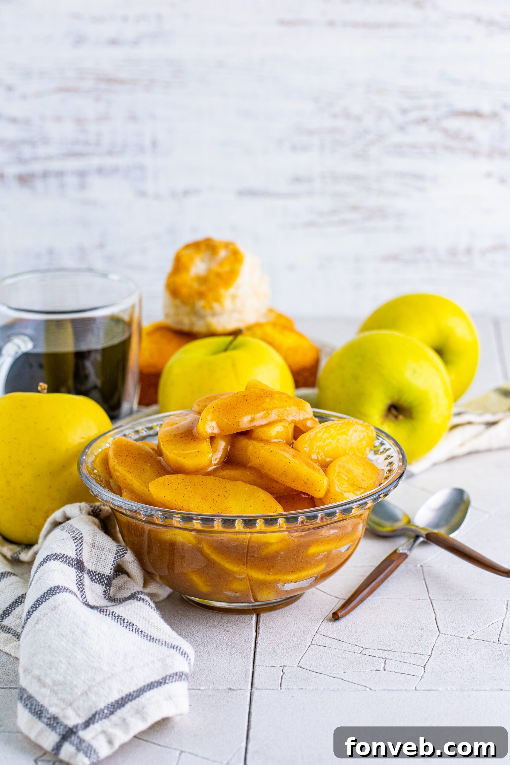 Front view of golden-brown Cracker Barrel Fried Apples in a clear glass bowl, highlighting their rich color and texture.