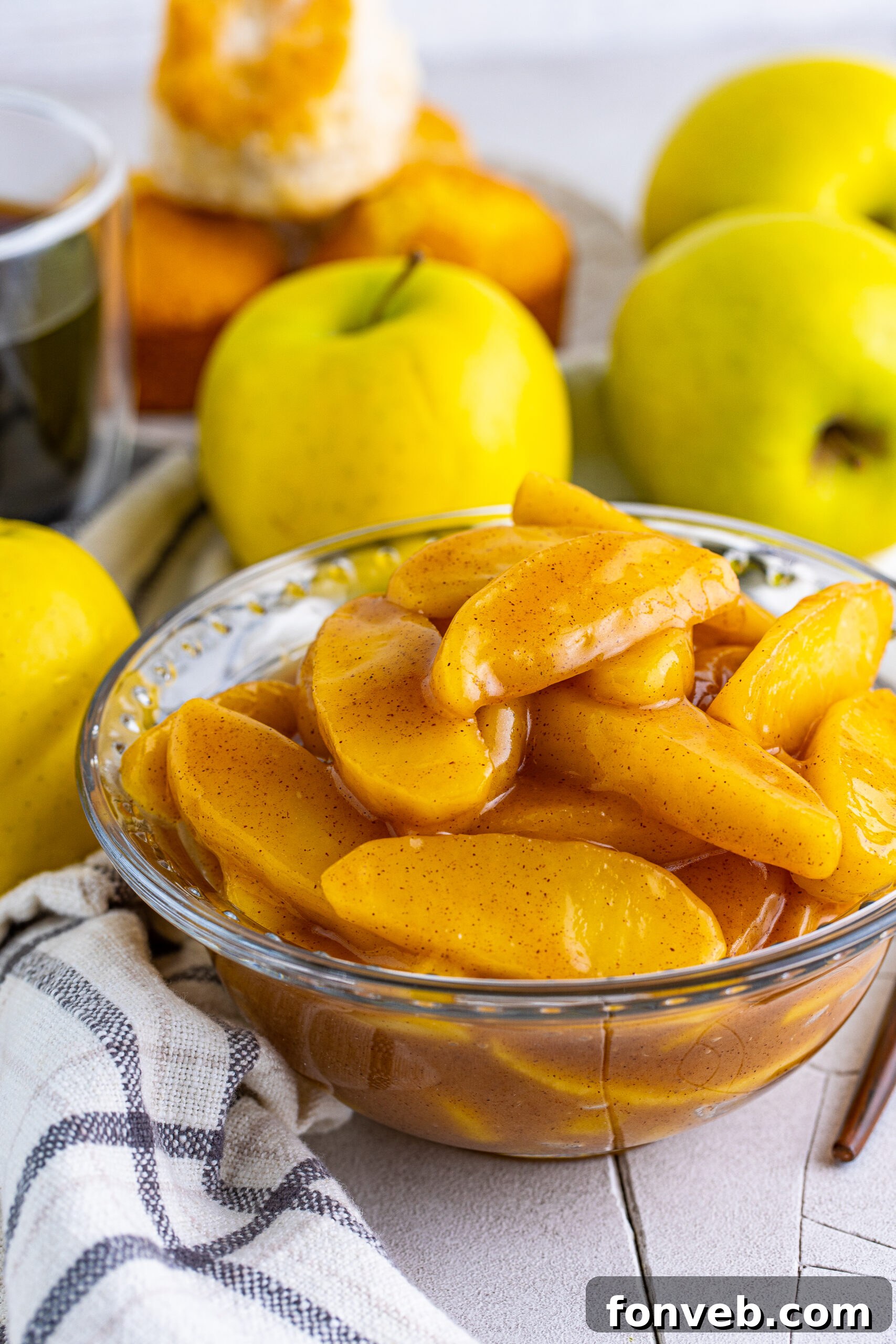Close up view of Cracker Barrel Fried Apples in a clear glass bowl, perfectly glazed and ready.