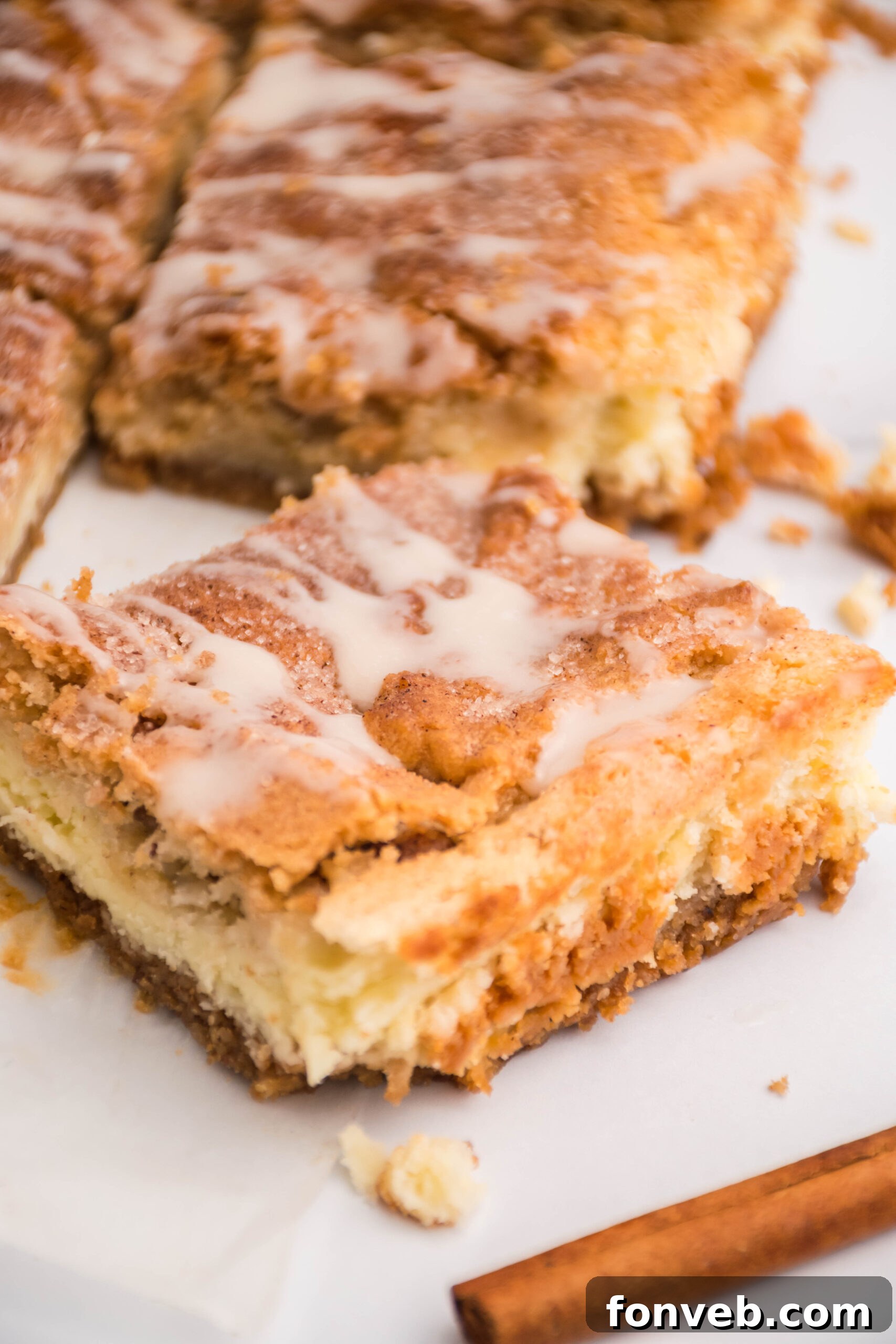 Close up view of a Snickerdoodle Cheesecake Bar, showing the soft cookie top and creamy filling.