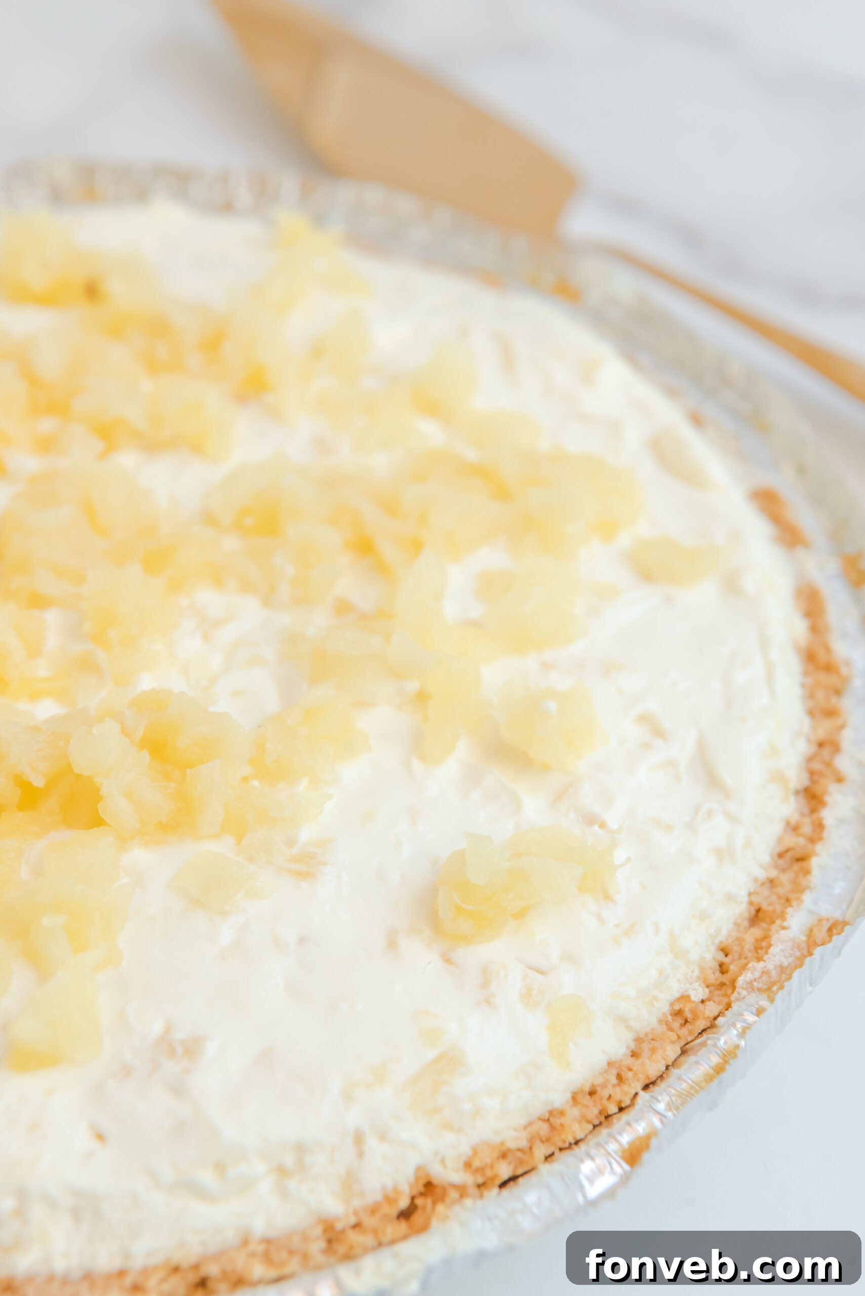 Close up view of No Bake Pineapple Cheesecake uncut.