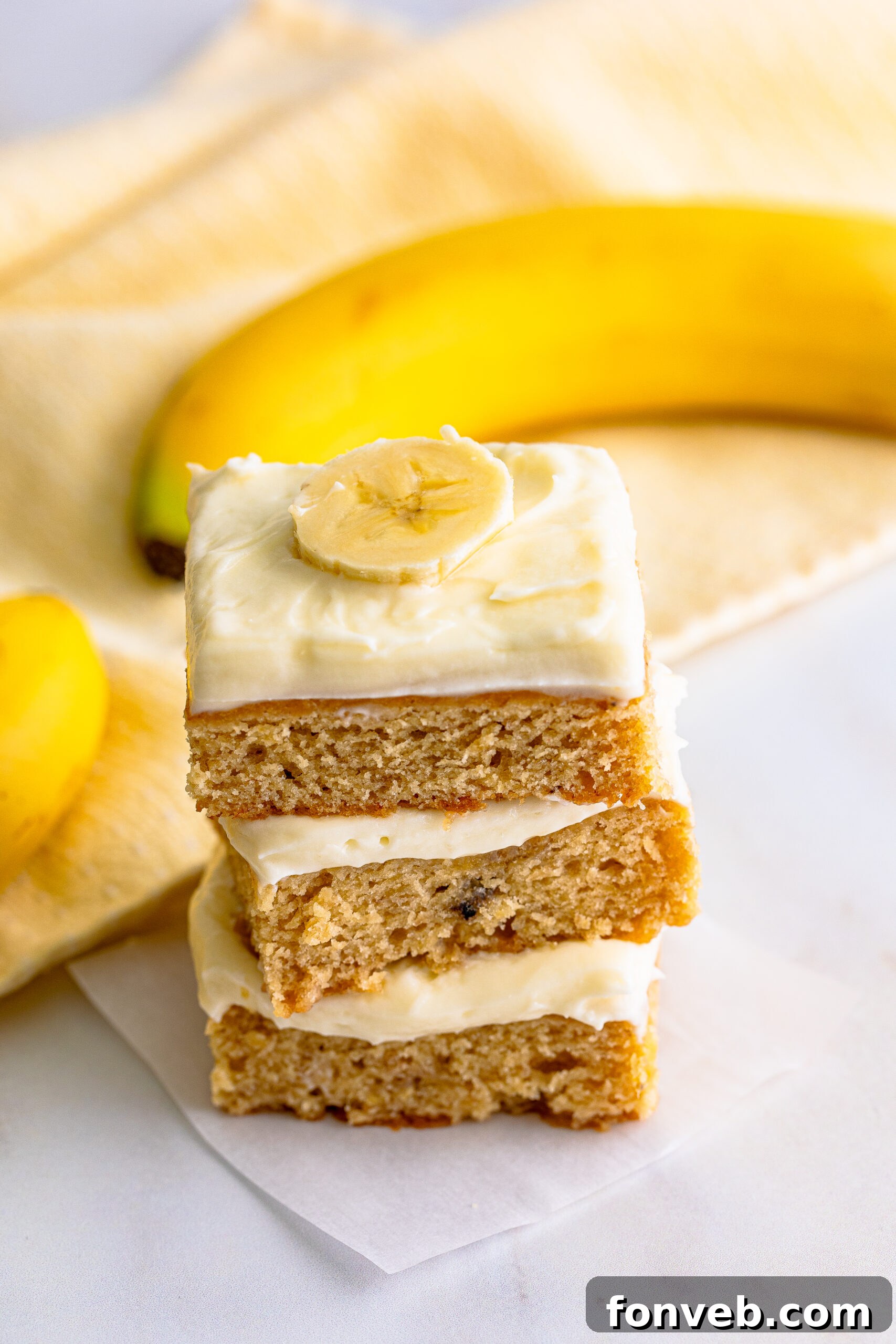 Front view of three Banana Brownies expertly stacked, showcasing their uniform golden-brown appearance.