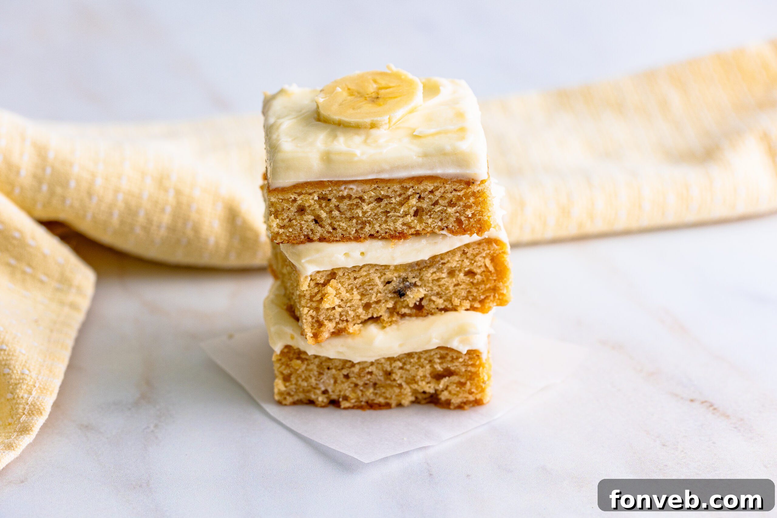 Front view of three Banana Brownies artfully stacked, showcasing their uniform shape and appealing texture.