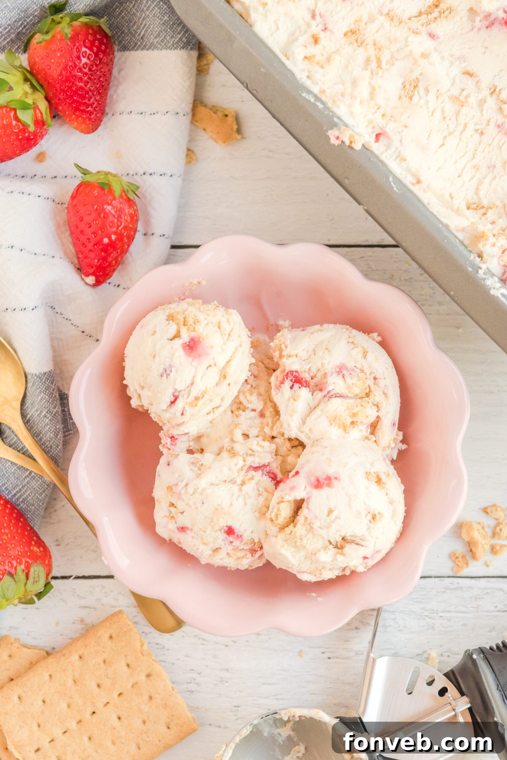Frozen Strawberry Cheesecake Dream 12 Overhead view of scoops of Strawberry Cheesecake Ice Cream in a pink bowl.