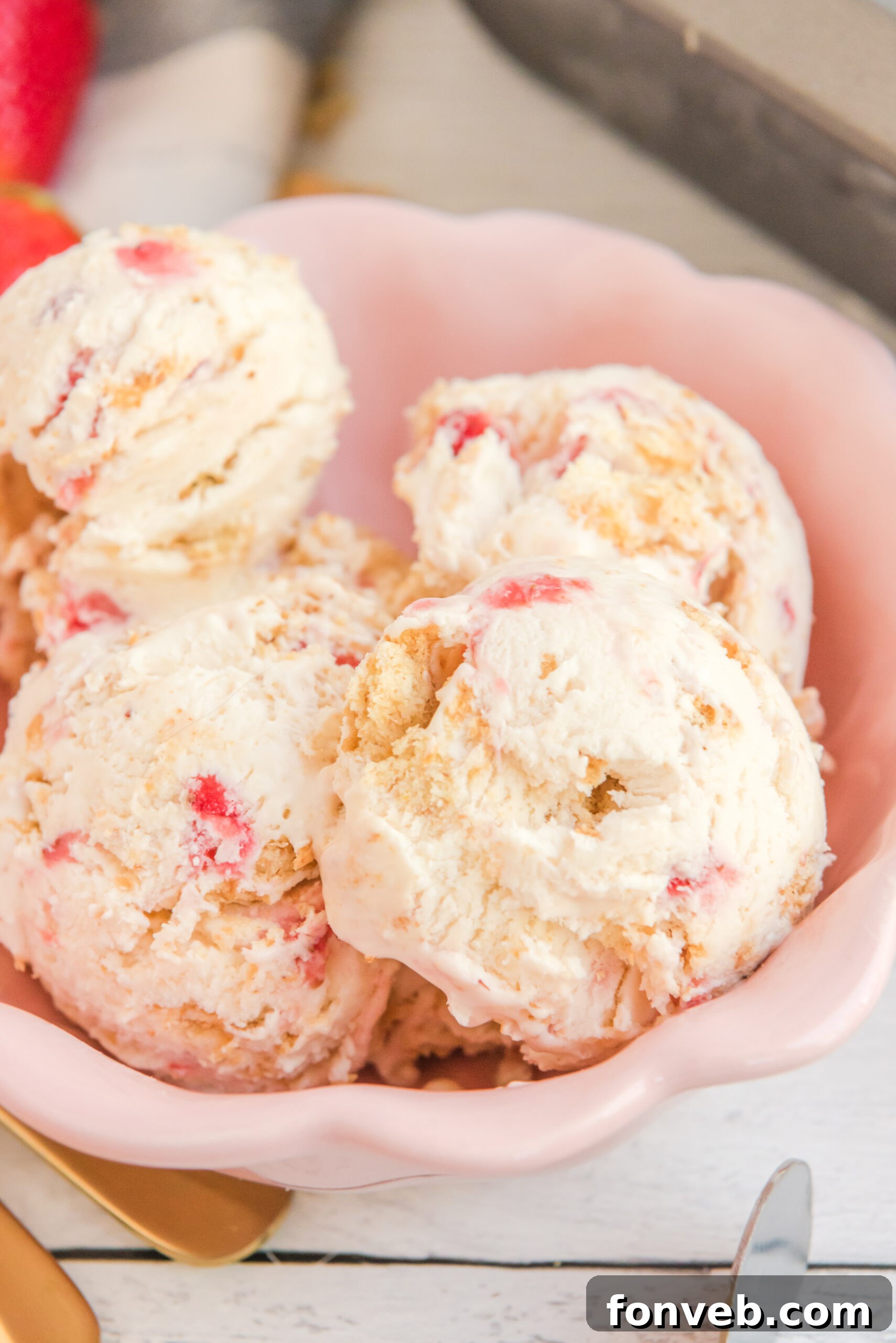 Frozen Strawberry Cheesecake Dream 13 Close up view of scoops of Strawberry Cheesecake Ice Cream in a pink bowl.