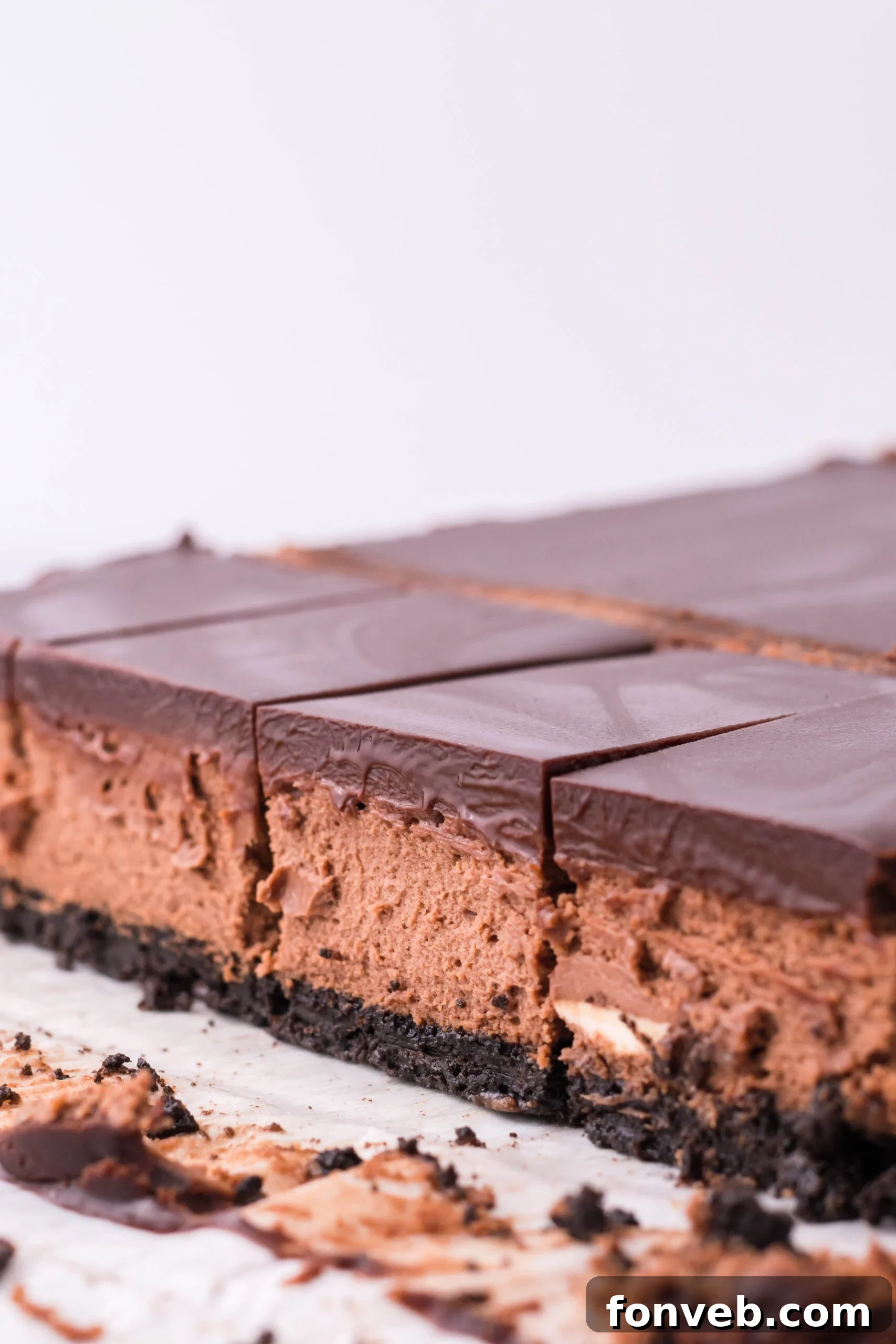 Side view of the three layers of the chocolate cheesecake bars.
