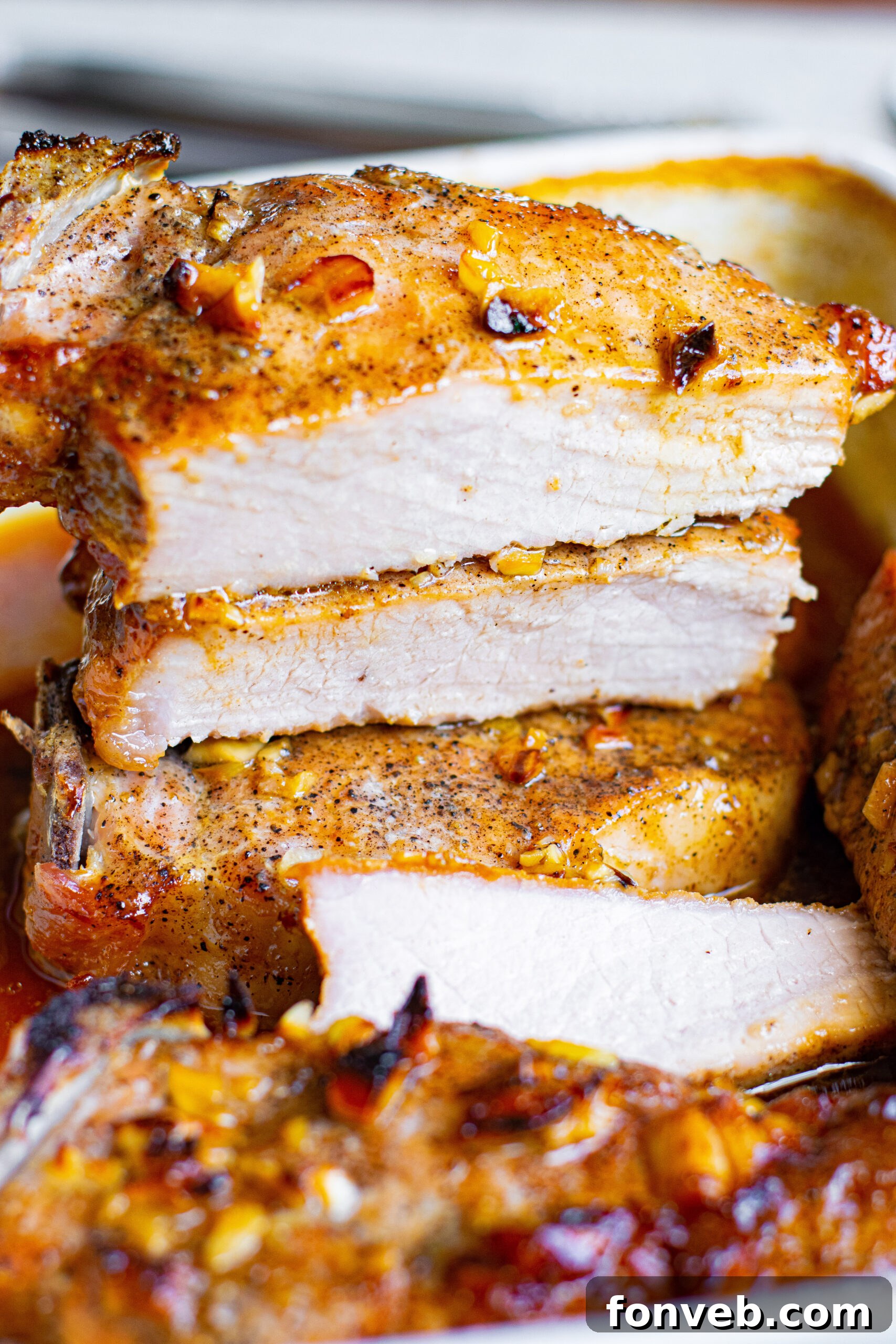 Perfectly glazed Honey Garlic Pork Chops in a white baking dish, ready to serve.