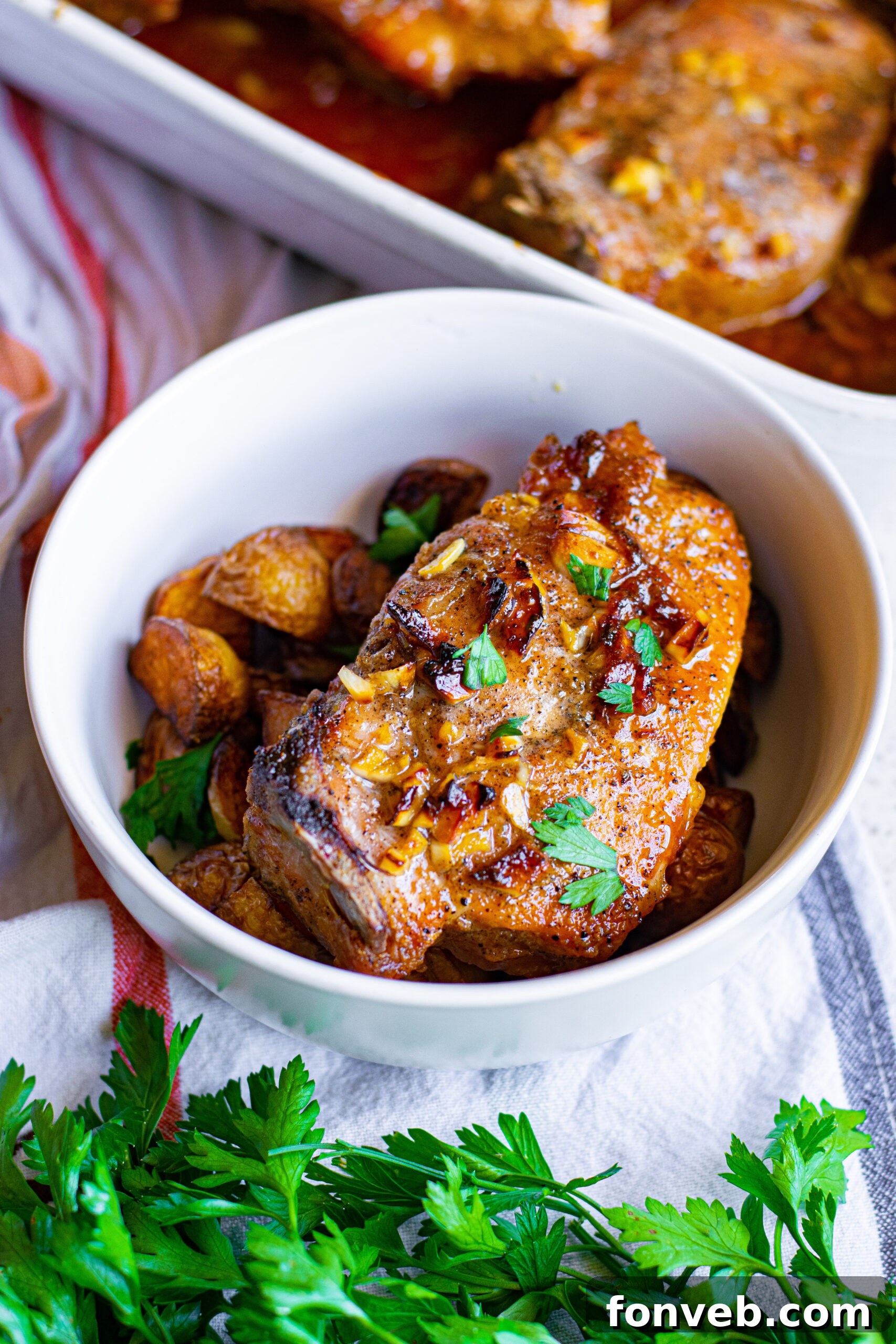 Overhead view of a plated Honey Garlic Pork Chop with mashed potatoes, drizzled with extra sauce.