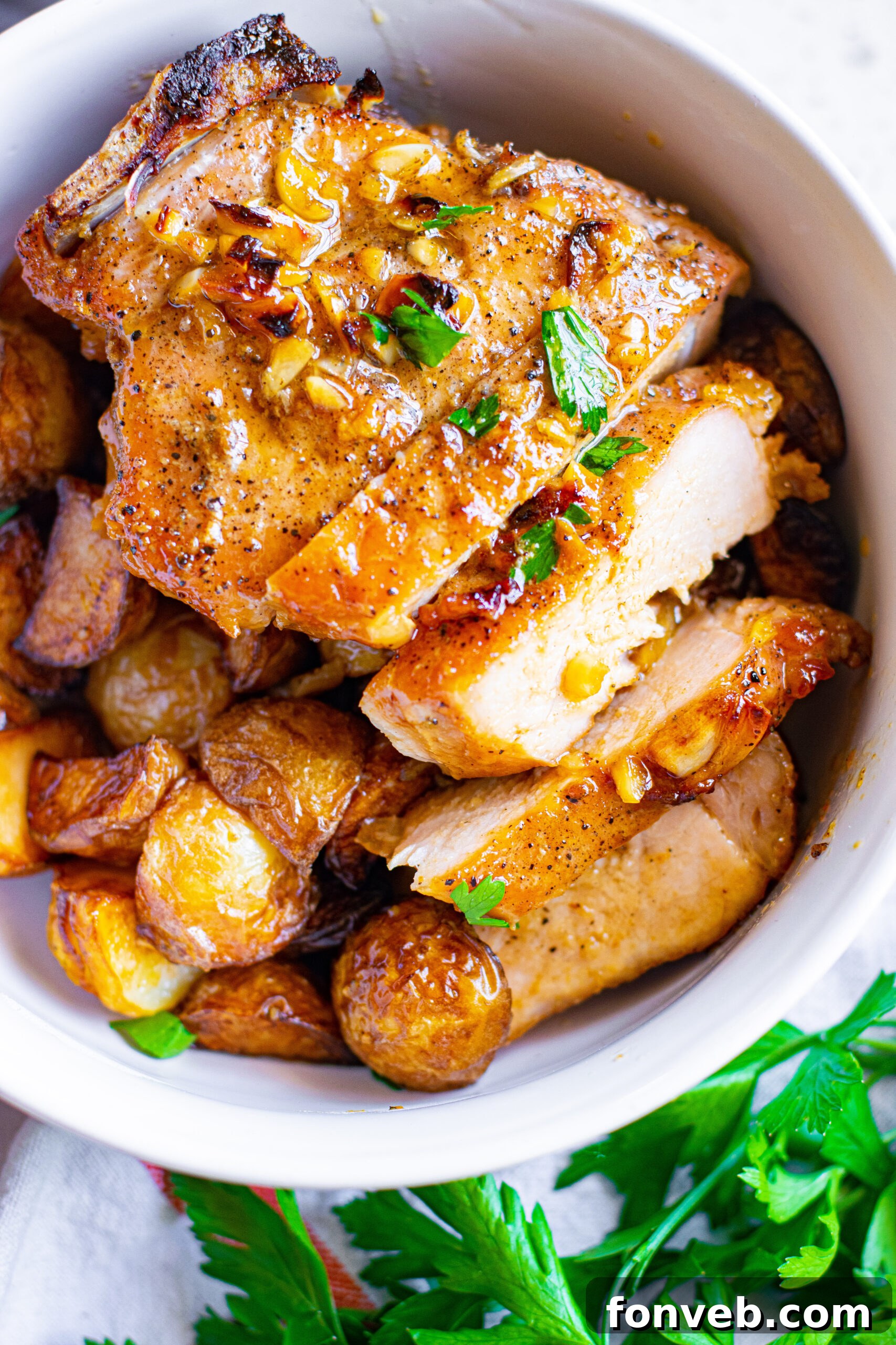 Close up view of Honey Garlic Pork Chops sliced into strips and served over mashed potatoes.