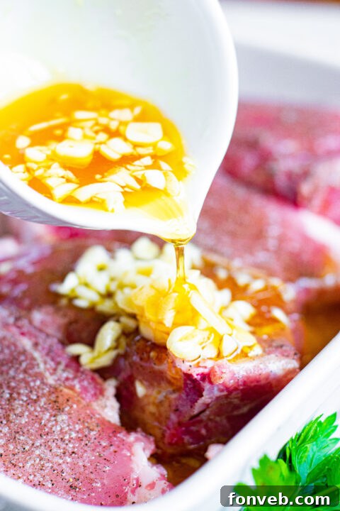 Honey garlic marinade being poured over pork chops.