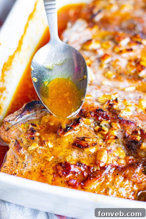 Honey Garlic Pork Chops baking in the oven, uncovered to achieve a golden glaze.