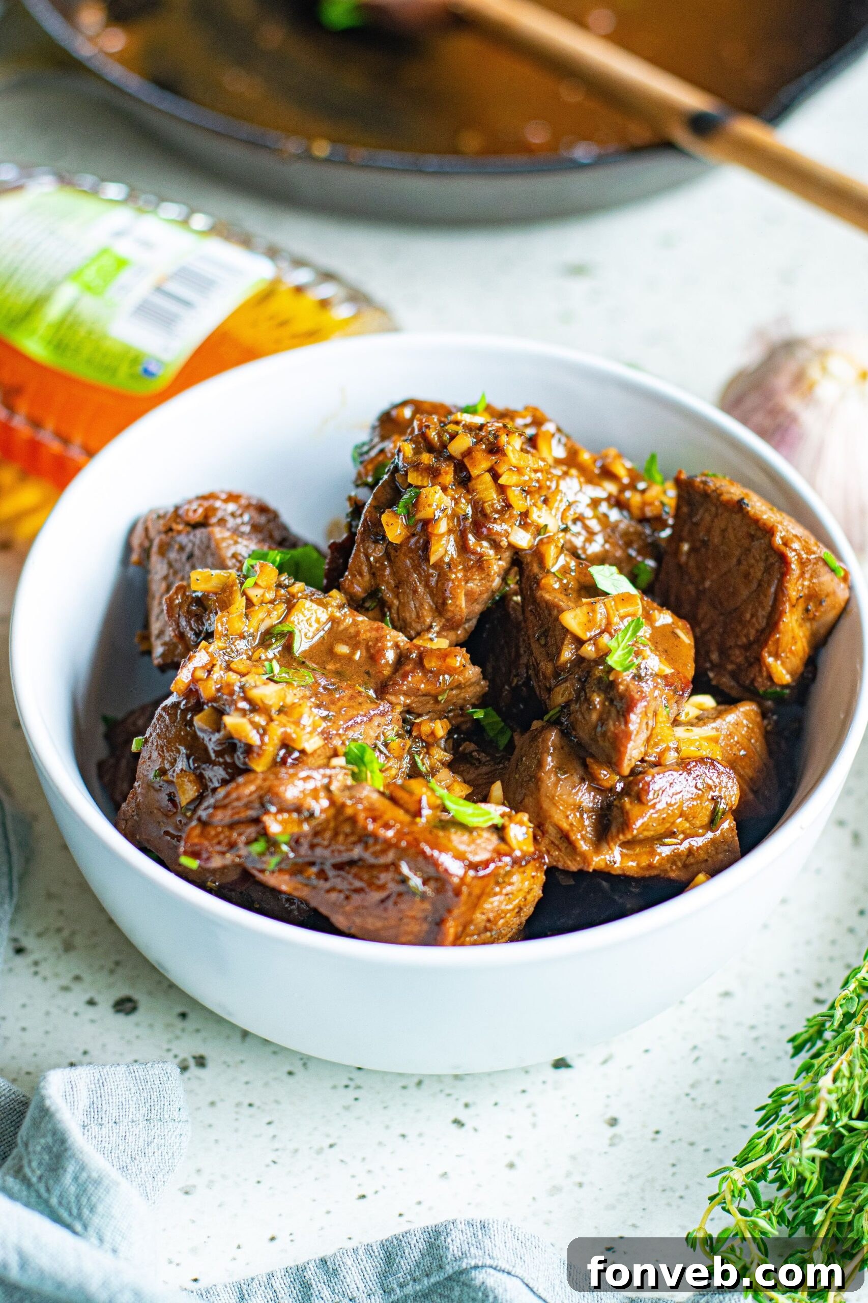 Front view of Garlic Honey Steak Bites in a white bowl.