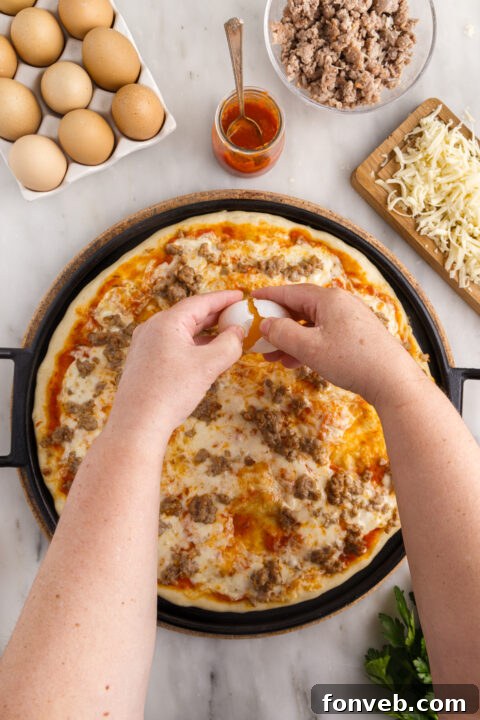 A vibrant and colorful Breakfast Pizza topped with a variety of breakfast elements.