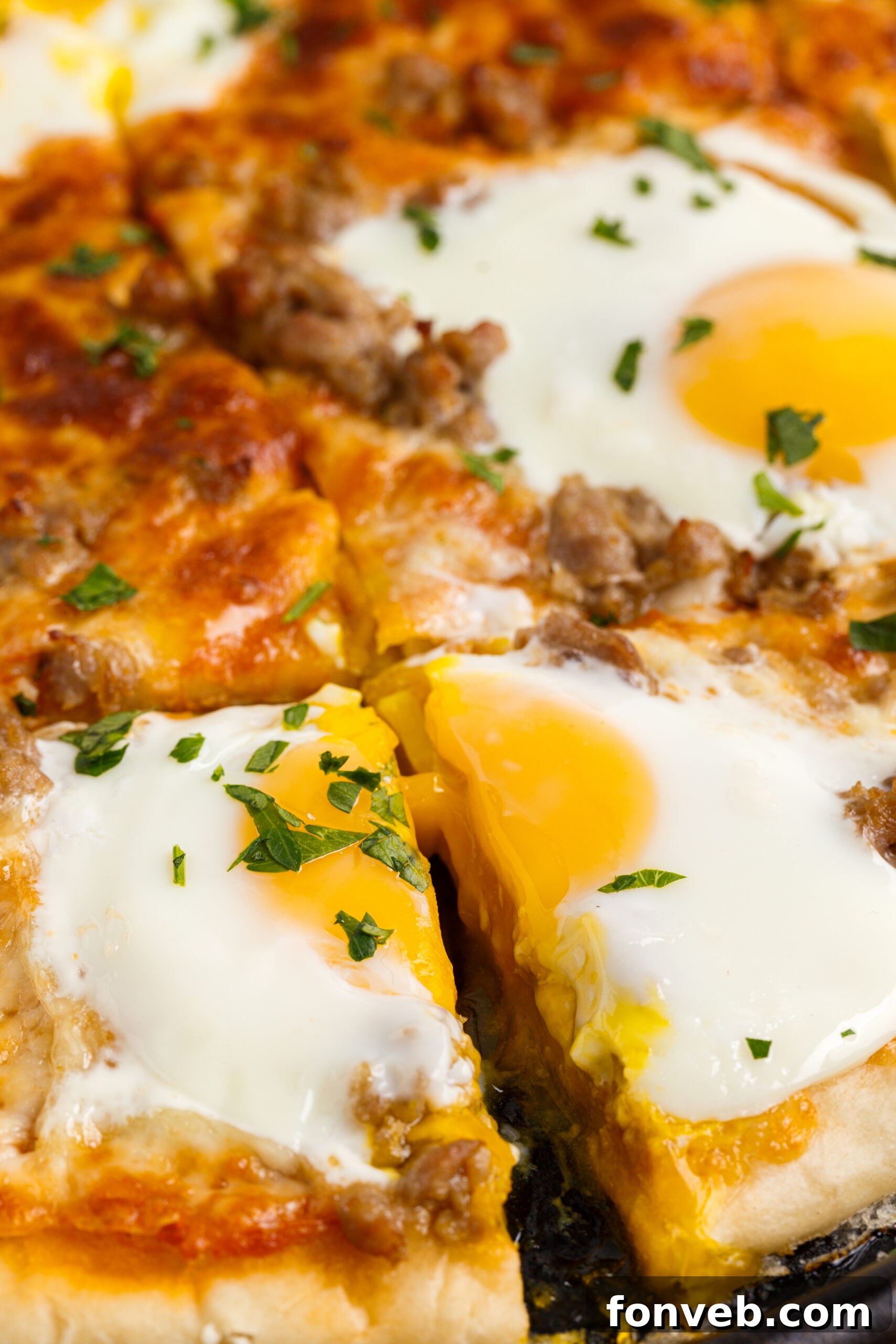 A close-up shot of square-cut Breakfast Pizza slices on a black pizza dish, ready to be served and enjoyed.