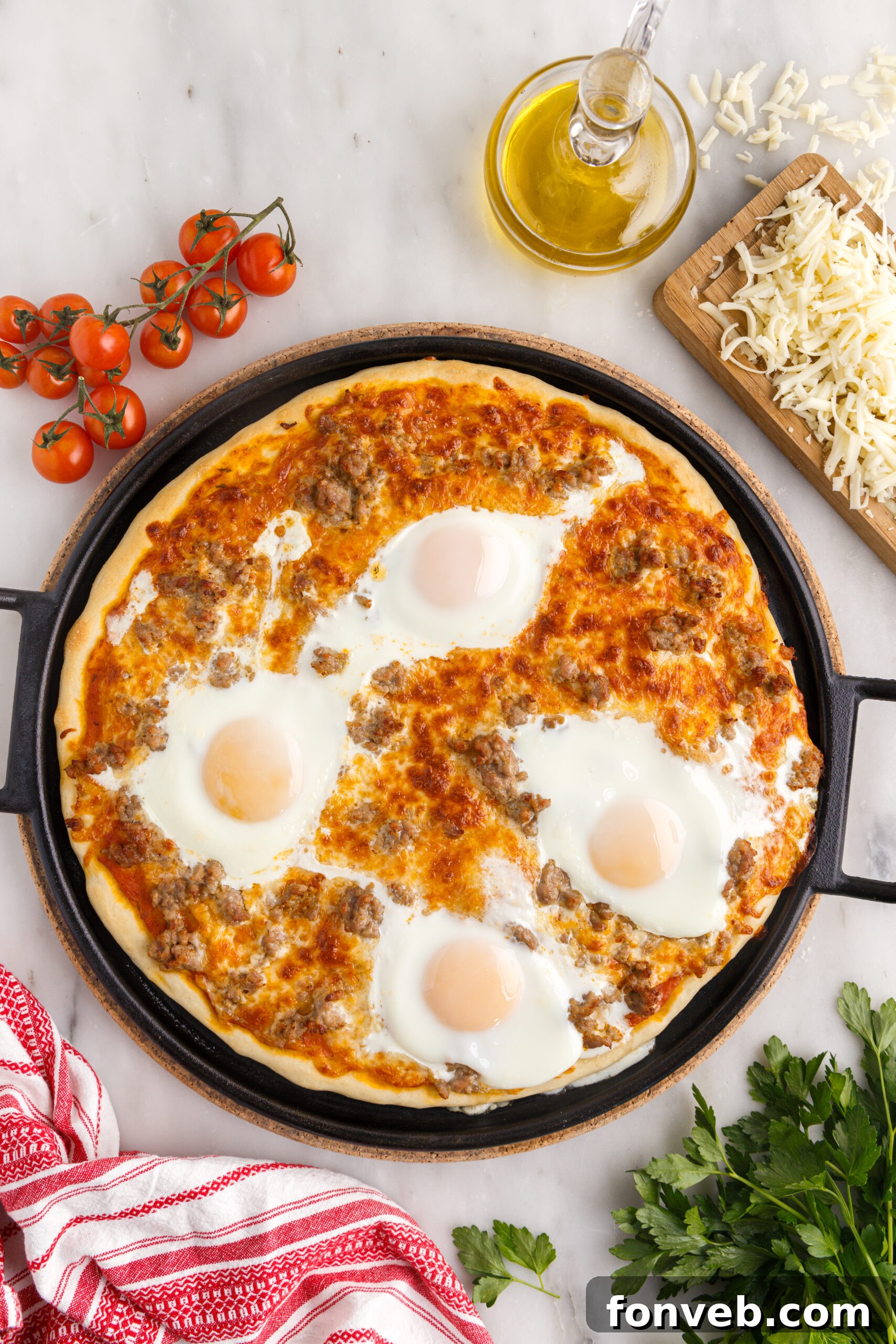 Overhead shot of a delicious Breakfast Pizza on a black pizza dish, showcasing its perfectly cooked crust and abundant toppings.