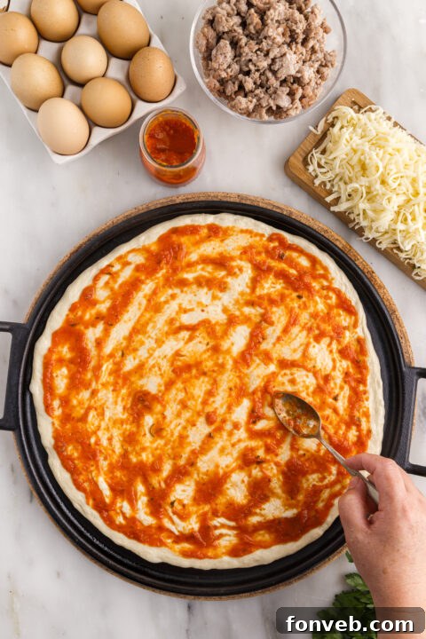 Close-up of a Breakfast Pizza section with a golden crust and diverse toppings.