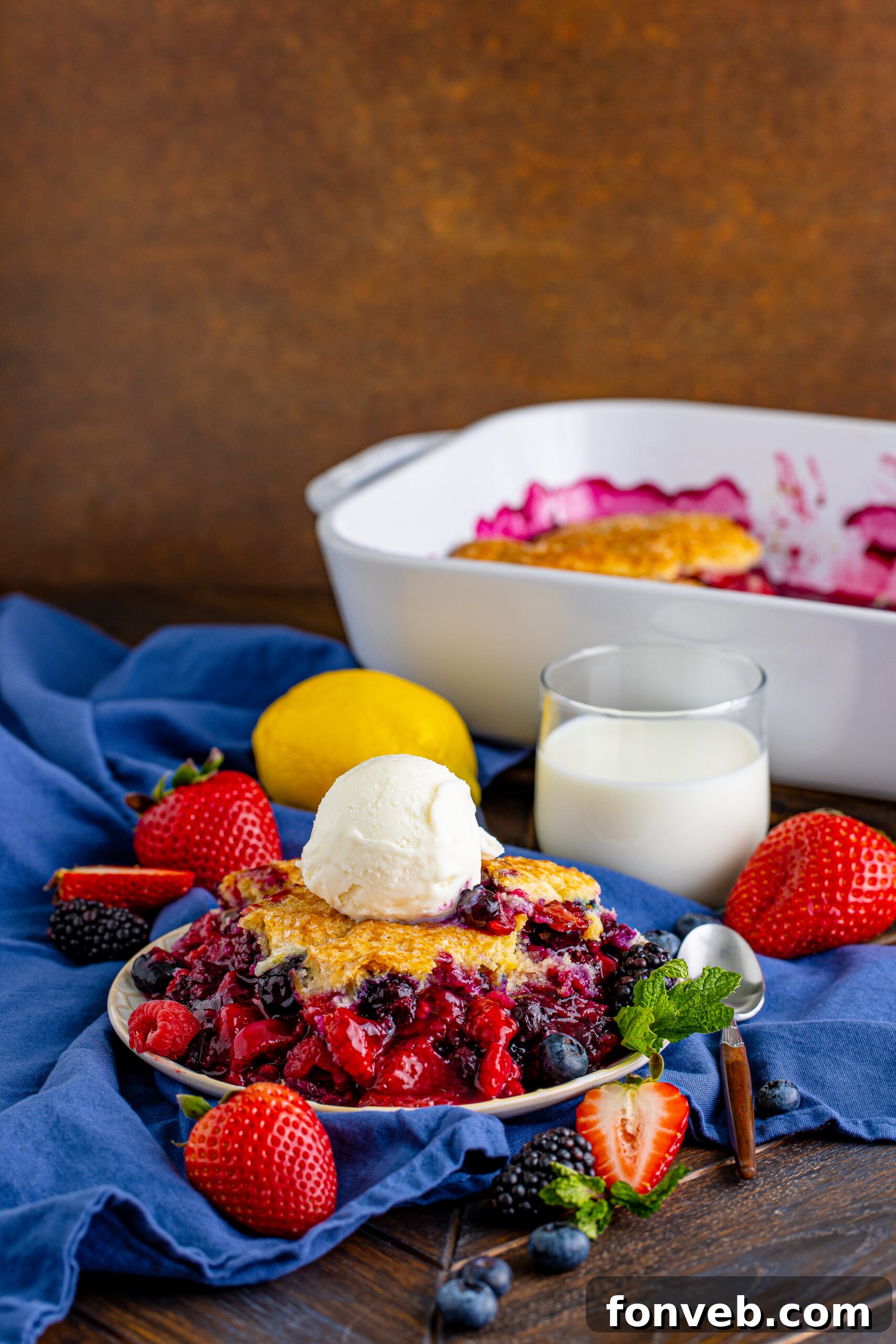 Front view of a Mixed Berry Cobbler with vanilla ice cream, highlighting the rich colors of the berries and the inviting warmth of the dessert.
